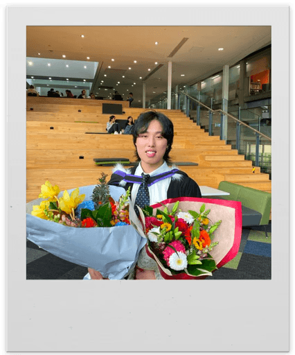 Simon holding graduation bouquets